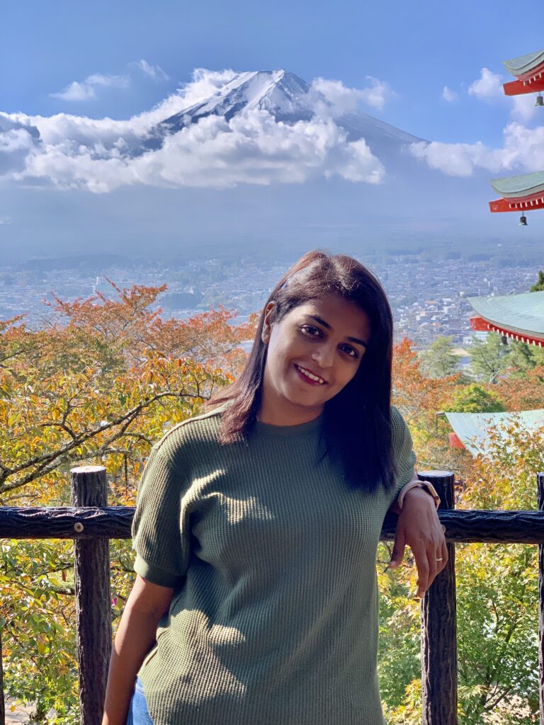 A girl standing with a backdrop of Mount Fuji