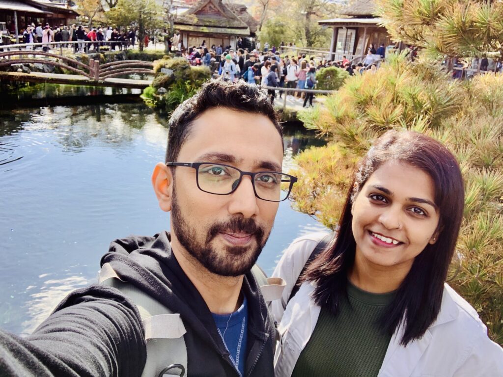 A couple standing by the pond