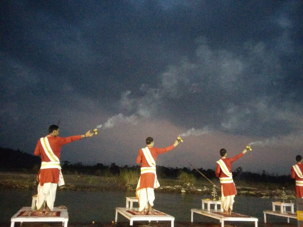 Priests performing a ritual on the banks of Ganga river in Rishikesh, India