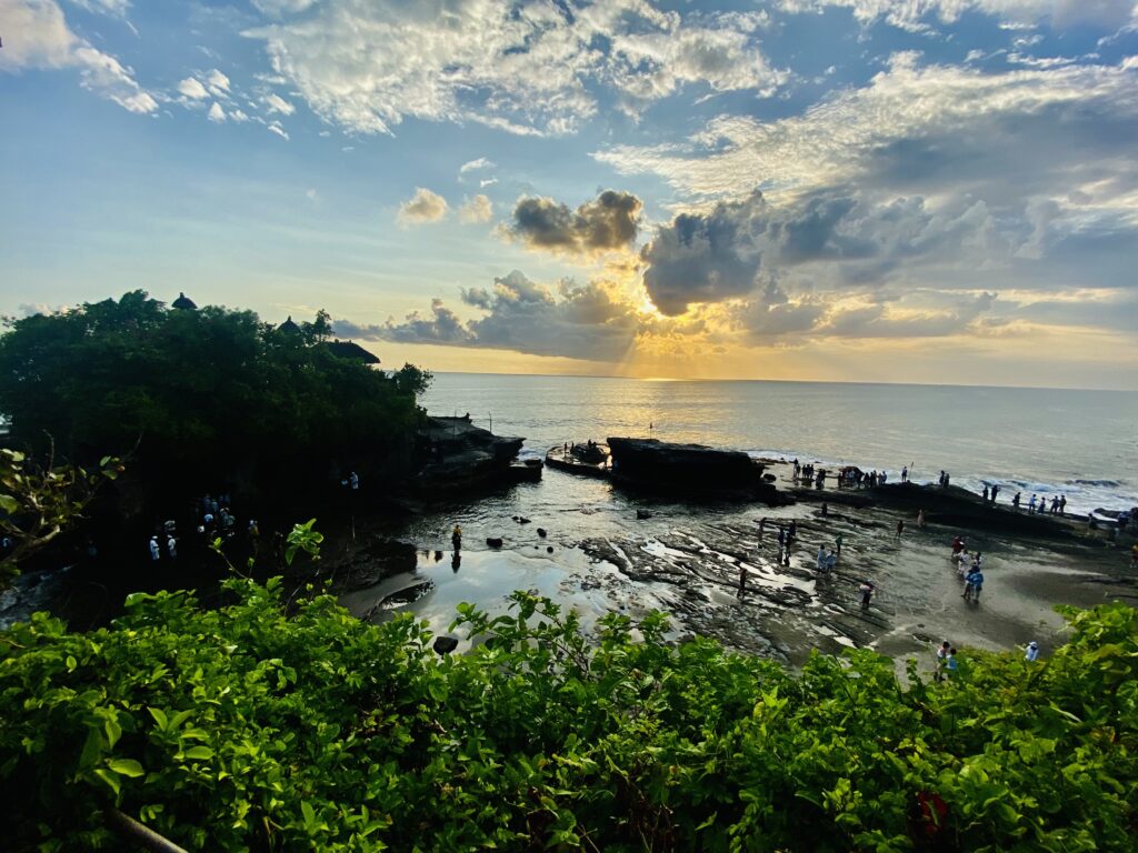 A temple in Bali in the sea during sunset